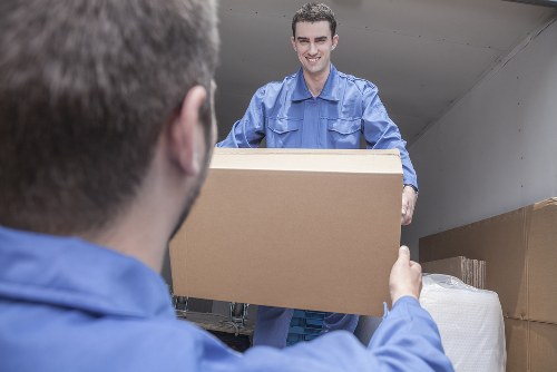 Student removals team handling boxes and furniture in Merton