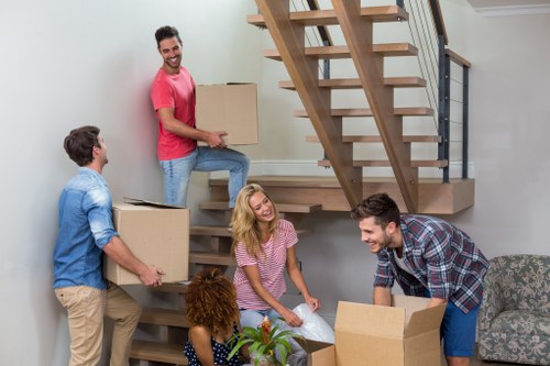 Furniture removals team handling large household items in Merton