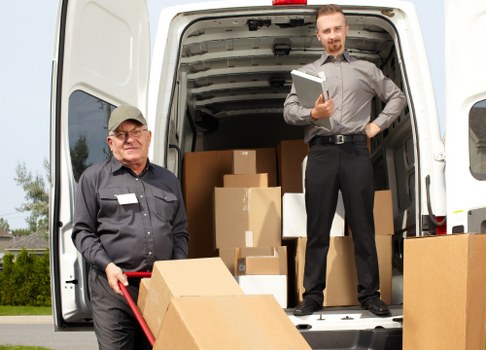 Removal van team carrying out a safety-checked loading operation