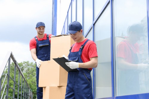 Removal van loading boxes and household items into a moving vehicle