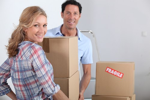 Professional movers handling furniture during a flat removal in Merton
